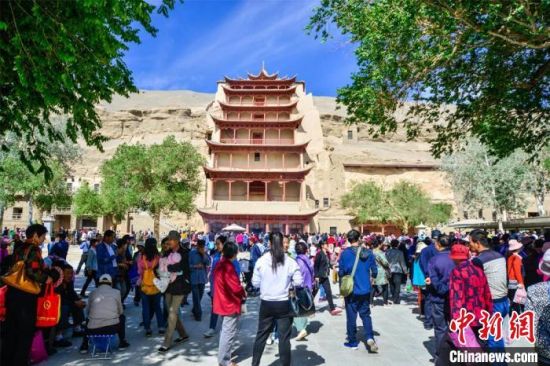 中國農(nóng)歷四月初八，敦煌民眾傳承歷史習(xí)俗，前往莫高窟燒香禮佛、祈福。(資料圖) 王斌銀 攝