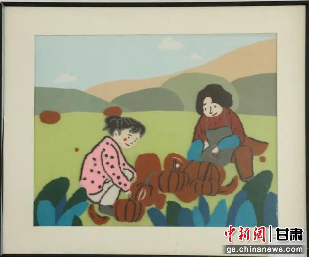 嘉峪關(guān)市新城鎮(zhèn)新城村農(nóng)業(yè)產(chǎn)業(yè)園區(qū)內(nèi)，母女兩人在摘南瓜。刺繡 馬艾米乃 繡稿 敬紅霞