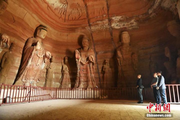 7月15日，游人參觀甘肅省平?jīng)鍪袥艽h百里石窟長廊中的南石窟寺1號窟。百里石窟長廊位于涇川縣境內(nèi)，由512個石窟、5眼窟中石井組成，現(xiàn)存王母宮石窟、鳳凰山石窟、南石窟寺、丈八寺石窟、羅漢洞石窟、太山寺石窟等規(guī)模較大的石窟群，還有數(shù)量眾多的小石窟群。南石窟寺開鑿于北魏永平三年，其中1號窟屬于大型七佛窟，七佛高達(dá)6米。中新社記者 李亞龍 攝